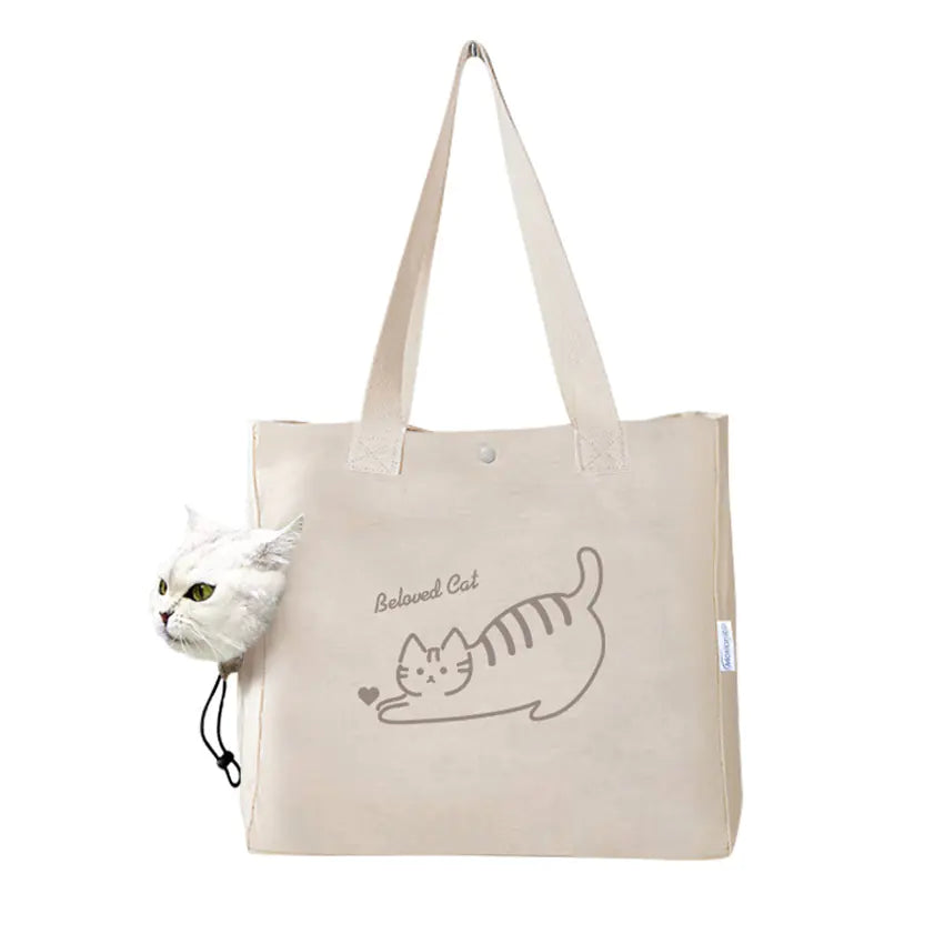 A white canvas handbag with a cute cat design and text 'CUTE CAT' is held by a person with a cat partially visible to the left of the frame.
