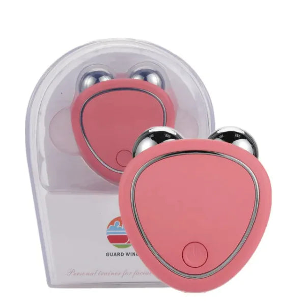 A portable facial micro-current beauty massager in pink color, displayed in its packaging, with a clear window showing the device inside.