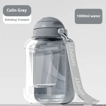 A portable pet water bottle in Colin Gray color with a capacity of 1000ml, featuring a drinking trumpet and a detachable food container.
