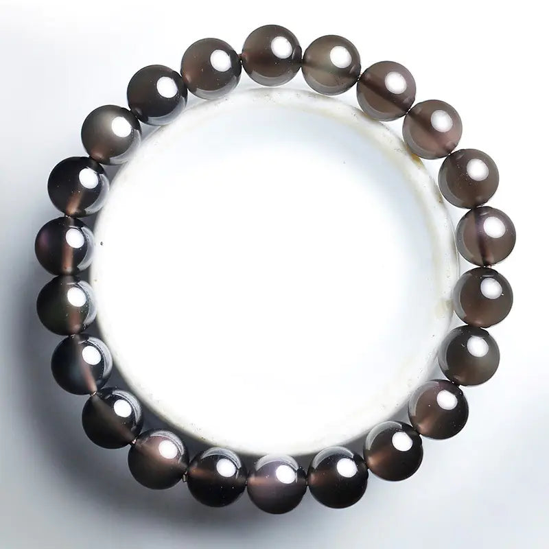 A black obsidian bracelet with a mystical PI Xiu symbol, designed for couples.