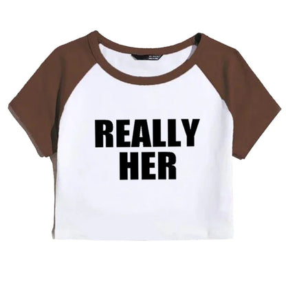 A gray and black cropped t-shirt with the text 'REALLY HER' printed in black on the front.