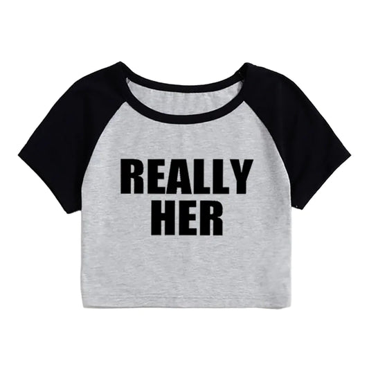 A gray and black cropped t-shirt with the text 'REALLY HER' printed in black on the front.