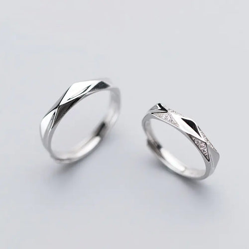 A pair of S925 silver rings, one with a larger band and the other with a smaller band, both featuring a grooved design.