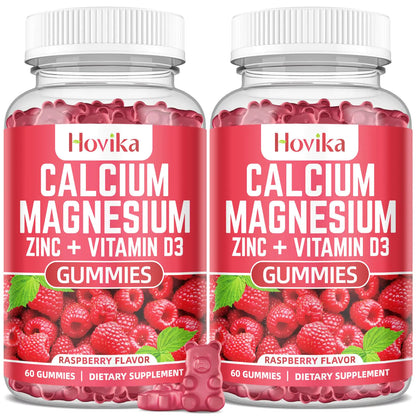 Two bottles of Hovika Calcium Magnesium Zinc + Vitamin D3 Gummies with raspberry flavor on a white background.