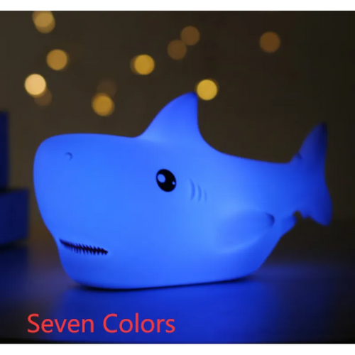 A blue LED night light designed in the shape of a shark, with the caption 'Seven Colors' indicating the number of available lighting modes.
