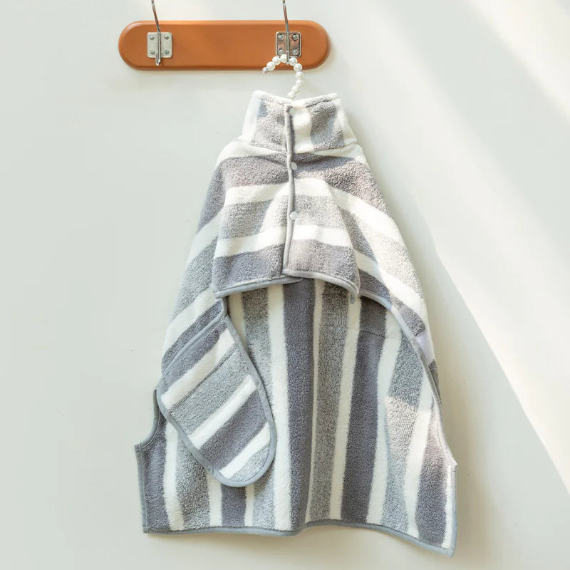 A striped bathrobe for dogs hanging on a wooden hanger against a white background.