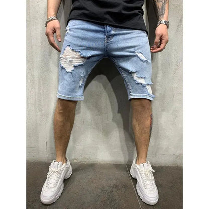 A pair of men's slim fit denim shorts with holes, worn with a black top and white sneakers.