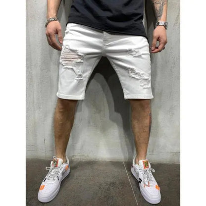 A pair of men's slim fit denim shorts with holes, worn with a black top and white sneakers.
