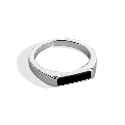 A sterling silver ring with a black insert and a platinum finish, displayed on a white background.