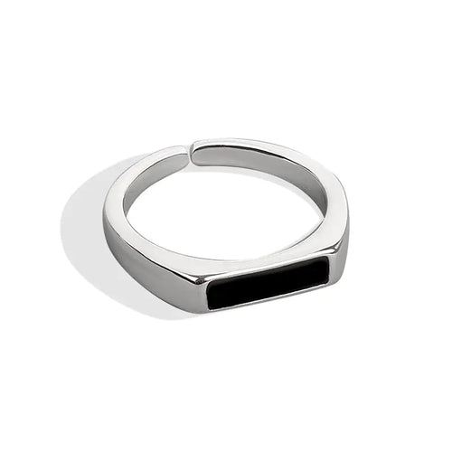 A sterling silver ring with a black insert and a platinum finish, displayed on a white background.