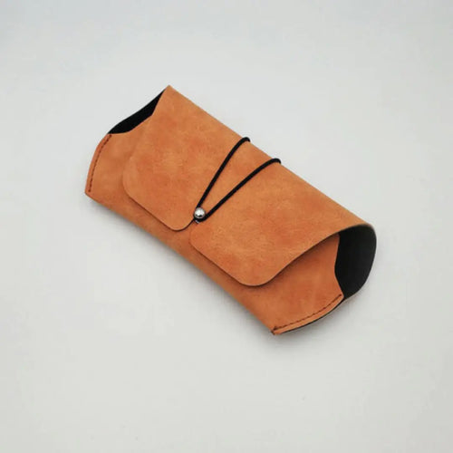 A brown velvet sunglasses case with a closed elastic band on a white background.