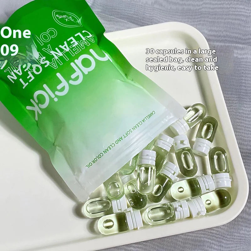 A travel size camellia cleansing oil product with capsules fanned out on a tray, with the packaging indicating it is a hydrating and easy-to-use facial cleanser.