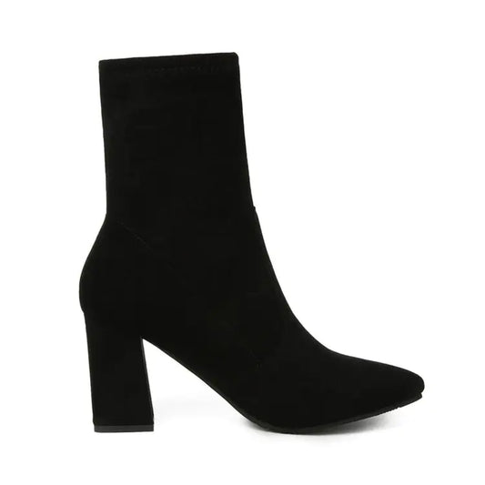 A black chunky heel ankle boot with a pointed toe and rubber sole.