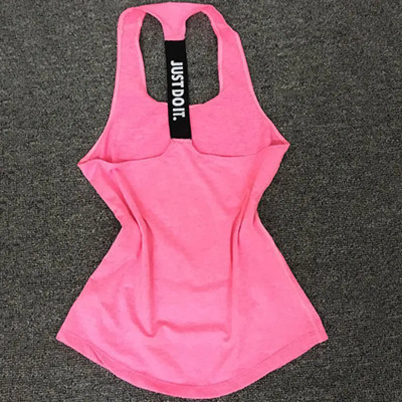 A pink women's running sports vest laid flat on a grey surface, showcasing the front view with a brand label that reads 'JUST DO IT'.